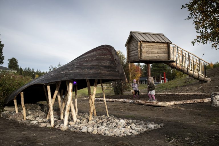 Ett hus på pålar och en båt uppochner
