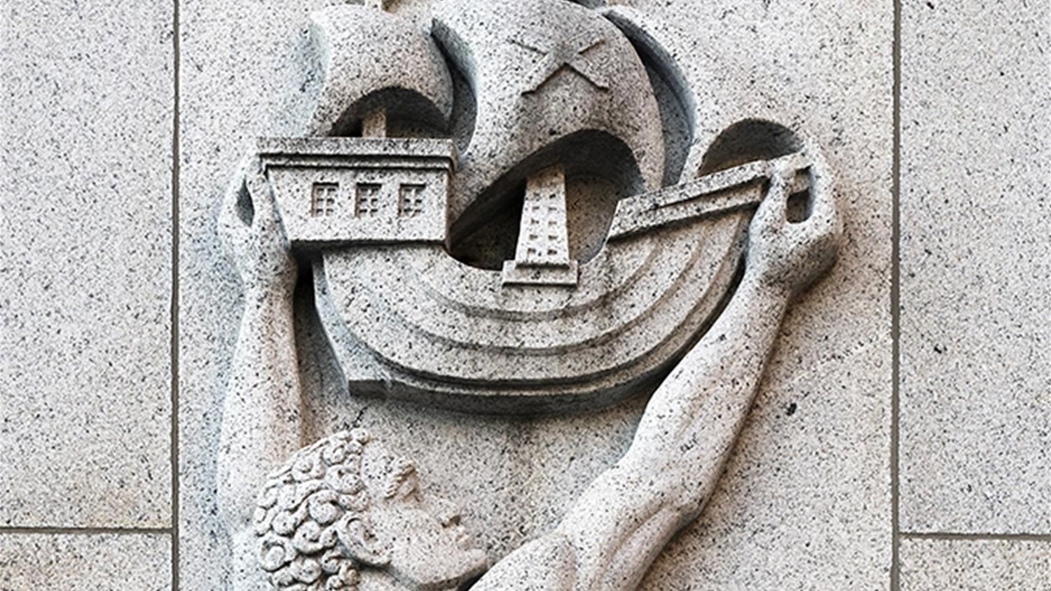 Relief of ship being lifted by a man.